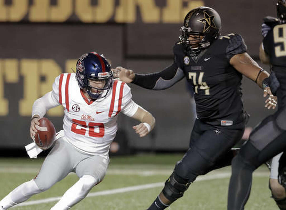 Vanderbilt defensive lineman Jay Woods (74) closes in on Mississippi quarterback Shea Patterson (20) for a sack and a loss of 9 yards in the first half of an NCAA college football game Saturday, Nov. 19, 2016, in Nashville, Tenn. (AP Photo/Mark Humphrey)