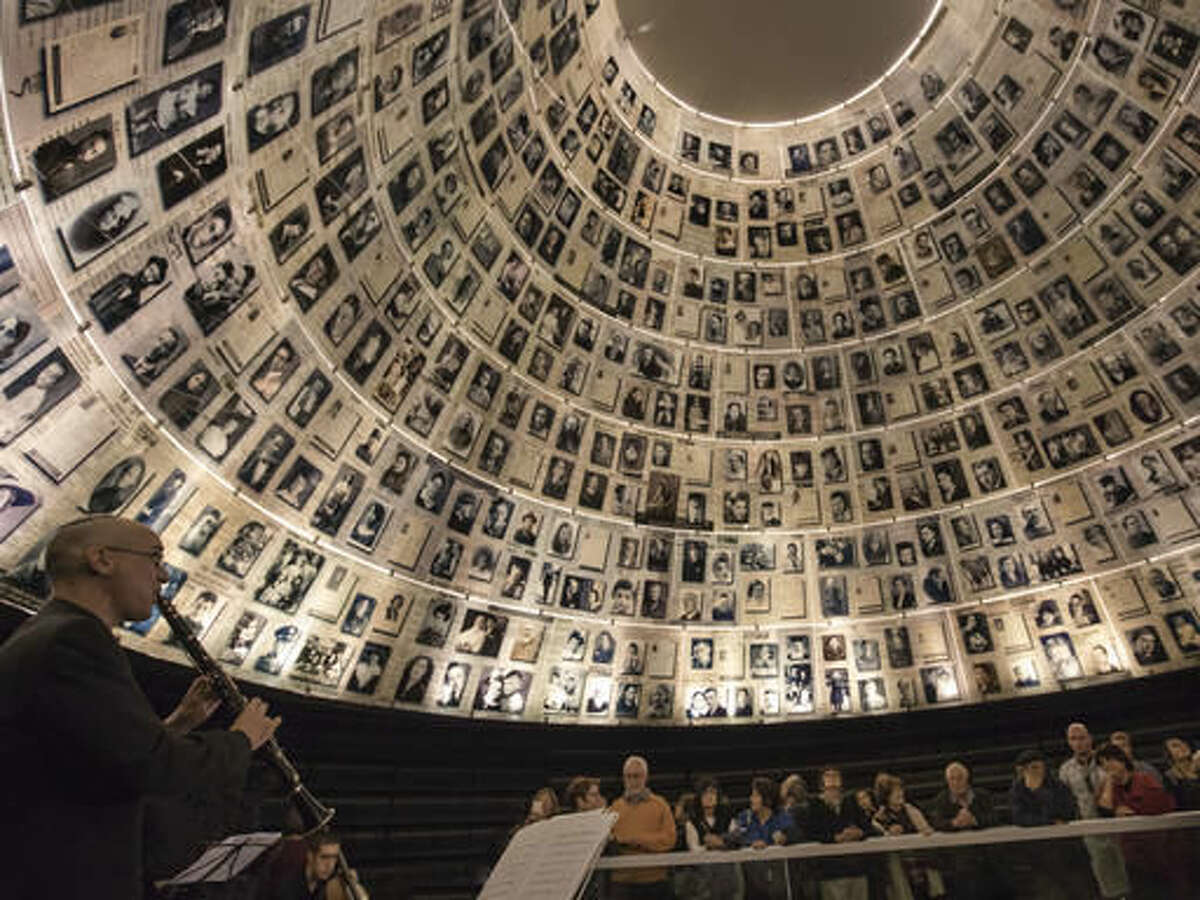 In this Monday, Nov. 21, 2016 photo, Israeli musician performs at Yad Vashem Holocaust Memorial in Jerusalem. For the first time in Yad Vashem's 63-year history, live music echoed through the halls of Israel's national Holocaust memorial in a somber tribute to the works of musicians who created a vibrant cultural life in the Terezin concentration camp before being sent to their deaths. (AP Photo/Tsafrir Abayov)