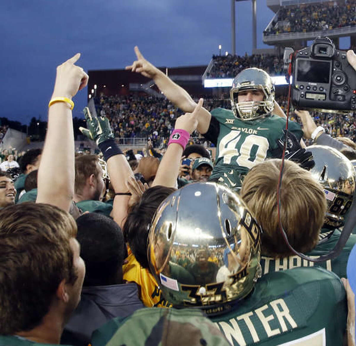 FILE - In this Oct. 11, 2014, file photo, Baylor place kicker Chris Callahan (40) is lifted up by the team after connecting for the game-winning field goal against TCU in the second half of an NCAA college football game, in Waco, Texas. Baylor won 61-58. The Baylor-TCU series started in 1899. (Rod Aydelotte/Waco Tribune-Herald via AP, File)