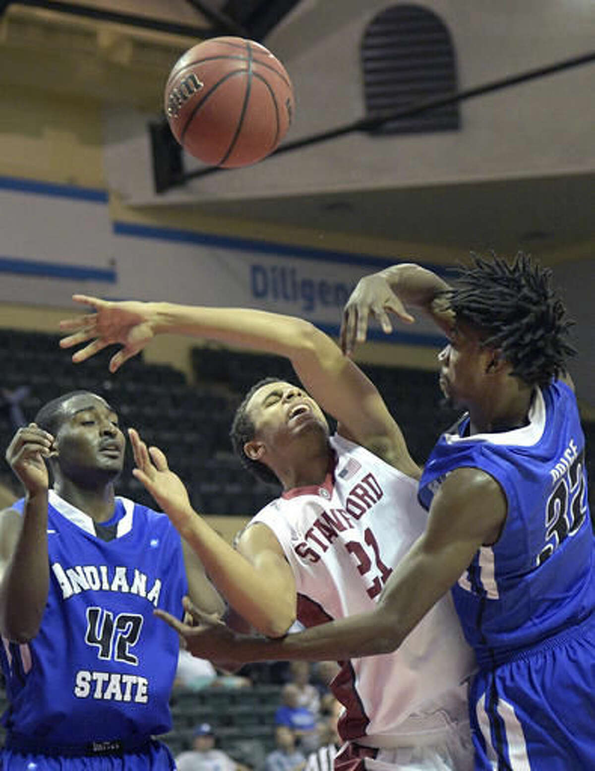Stanford forward Cameron Walker (21) is fouled by Indiana State guard Laquarious Paige (32) while going up for a shot as center T.J. Bell (42) helps defend during the second half of an NCAA college basketball game at the AdvoCare Invitational tournament in Lake Buena Vista, Fla., Friday, Nov. 25, 2016. Stanford won 65-62. (AP Photo/Phelan M. Ebenhack)