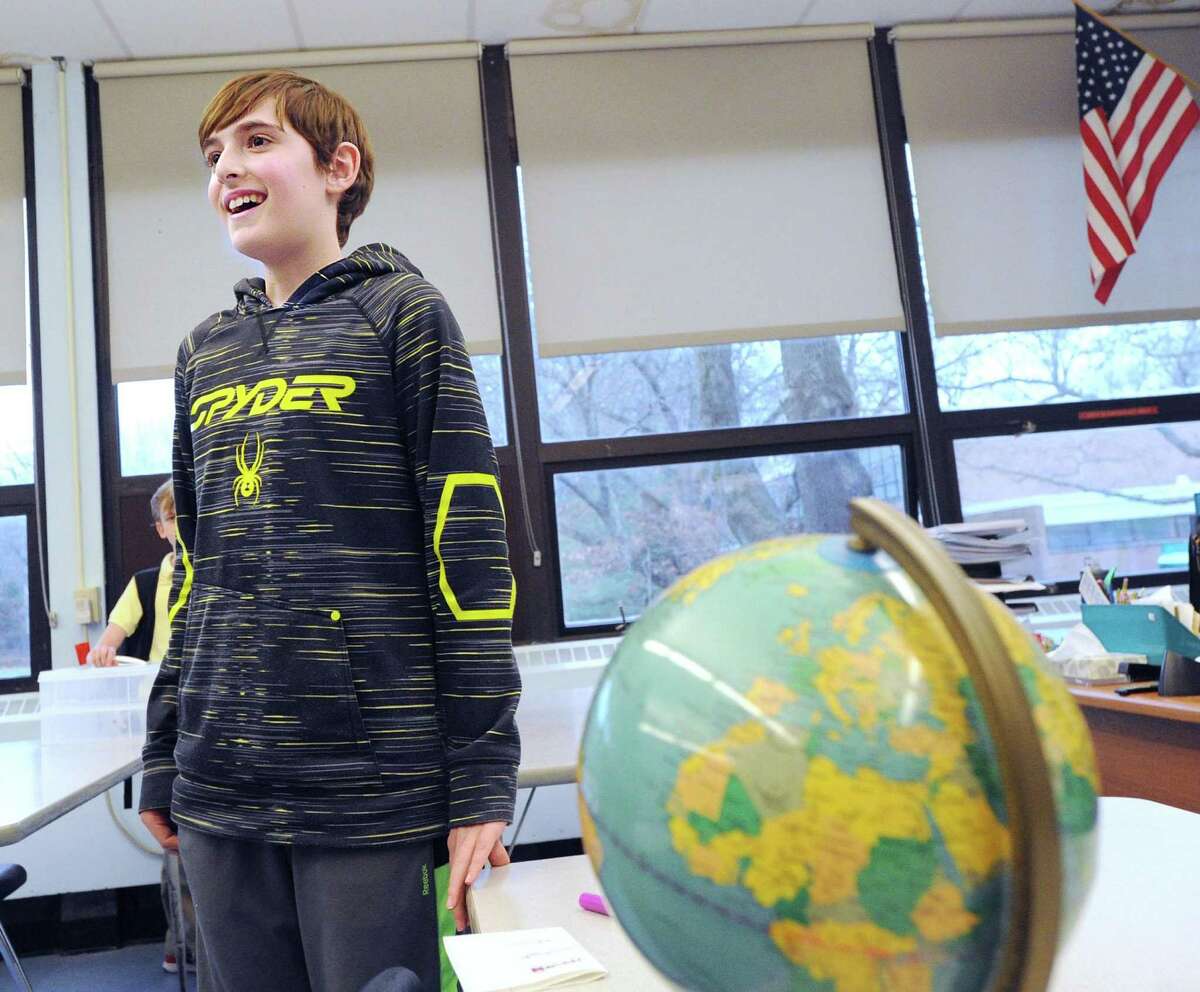 Eastern Middle School sixth-grader Elliot Staple, 11, miles after winning the school’s Geography Bee sponsored by National Geographic on Tuesdy in the classroom of social studies teacher Jill Bleemer in the Riverside section of Greenwich. Kejun Wang, 12, a seventh-grade student, finished in second place.