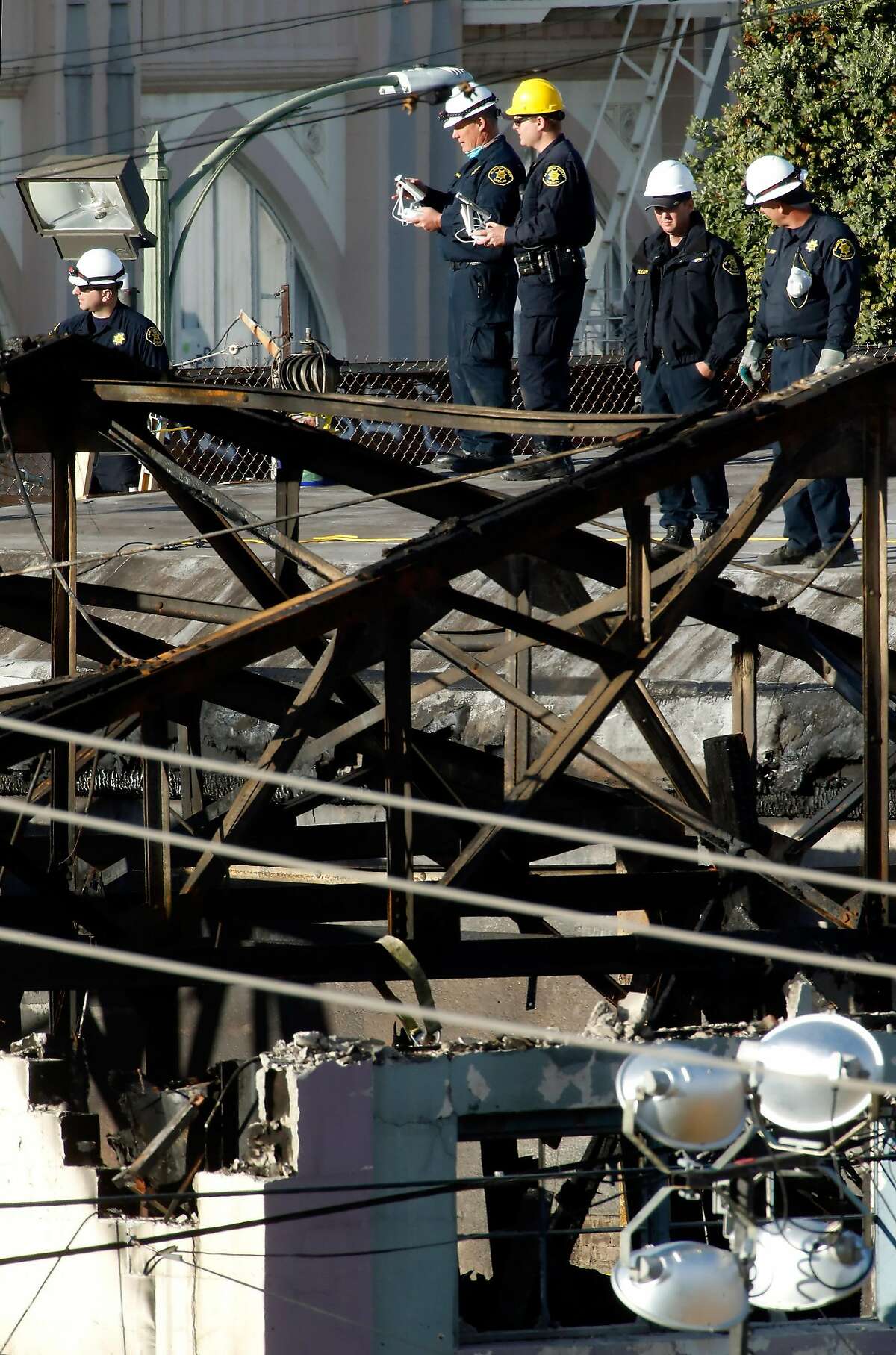 Alameda County Sherrif's officers keep an eye on a quadcopter that they used to look into the destroyed Ghost Ship warehouse as recovery efforts came to a close following the fire that claimed 36 lives in Oakland, Calif., on Tuesday, December 6, 2016.