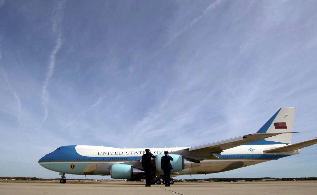 FILE - In this Nov. 6, 2016 file photo, military personnel salute as Air Force One, with President Barack Obama aboard, departs at Andrews Air Force Base, Md. President-elect Donald Trump wants the government's contract for a new Air Force One canceled. ( AP Photo/Jose Luis Magana)