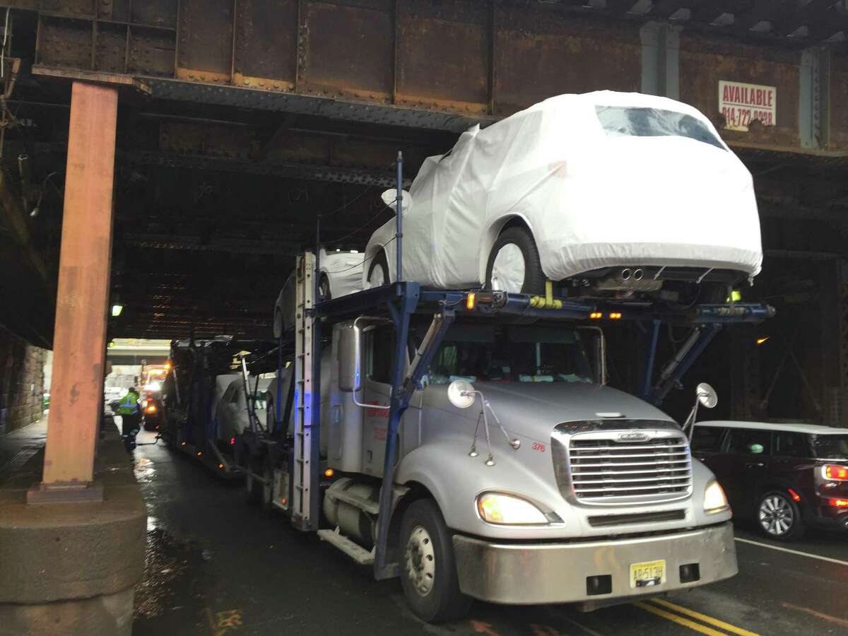 Car carrier strikes Stamford railroad bridge