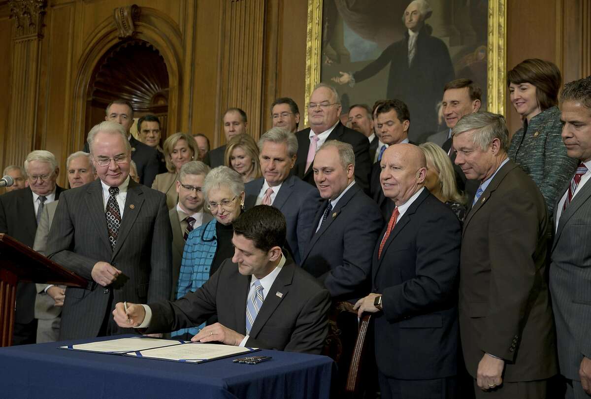 FILE � House Speaker Paul Ryan, center, signs legislation to repeal the Affordable Care Act, which was later vetoed by President Barack Obama, in Washington, Jan. 7, 2016. After a Donald Trump win, Republicans in Congress are gearing up to get rid of the health care act immediately, but are likely to delay the effective date a few years to slowly phase it out. (Stephen Crowley/The New York Times)