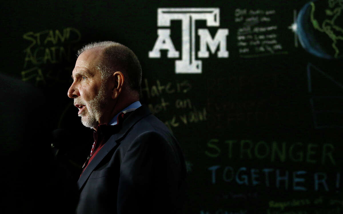 Texas A&M President Michael Young speaks in front of a message board outside Kyle Field where an "Aggies United" event is scheduled for Tuesday evening at the university Tuesday, Dec. 6, 2016, in College Station, Texas. The event is taking place at the same time Richard Spencer, who leads a movement that mixes racism, white nationalism and populism, is set to speak at a separate event at the university after being invited by a former student. (Stephen Spillman/Austin American-Statesman via AP)