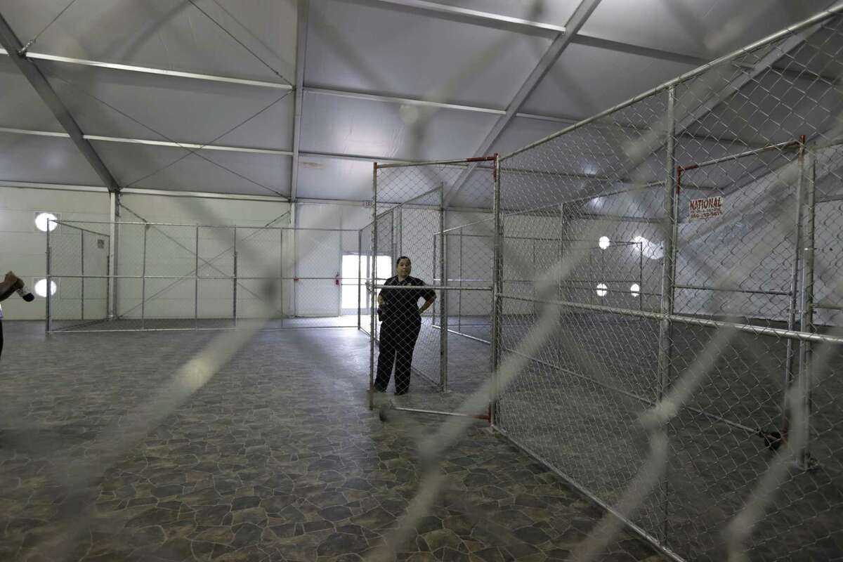 A Customs and Border Protection agent stands in a temporary holding facility near the Donna-Rio Bravo International Bridge.