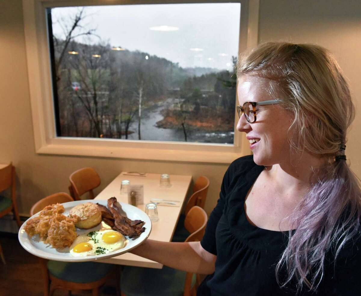 Server Ashley Evans serves up breakfast with a view, eggs, hash browns, bacon and a biscuit under a picture window at Gracie's Luncheonette on Main Street Wednesday Nov. 30, 2016 in Leeds, NY. (John Carl D'Annibale / Times Union)