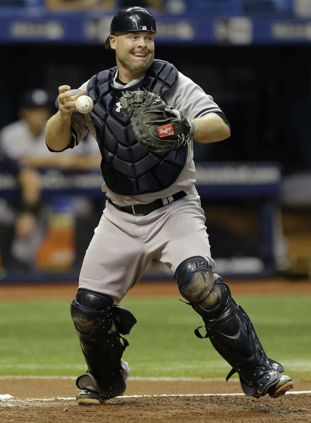 FILE - In this Monday, Sept. 14, 2015 file photo, New York Yankees catcher Brian McCann loses the baseball after forcing Tampa Bay Rays' Asdrubal Cabrera at home plate on a fielder's choice by Kevin Kiermaier during the second inning of a baseball game in St. Petersburg, Fla. The New York Yankees traded veteran catcher Brian McCann and $11 million to the Houston Astros on Thursday, Nov. 17, 2016 for a pair of young minor league pitchers.(AP Photo/Chris O'Meara, File)
