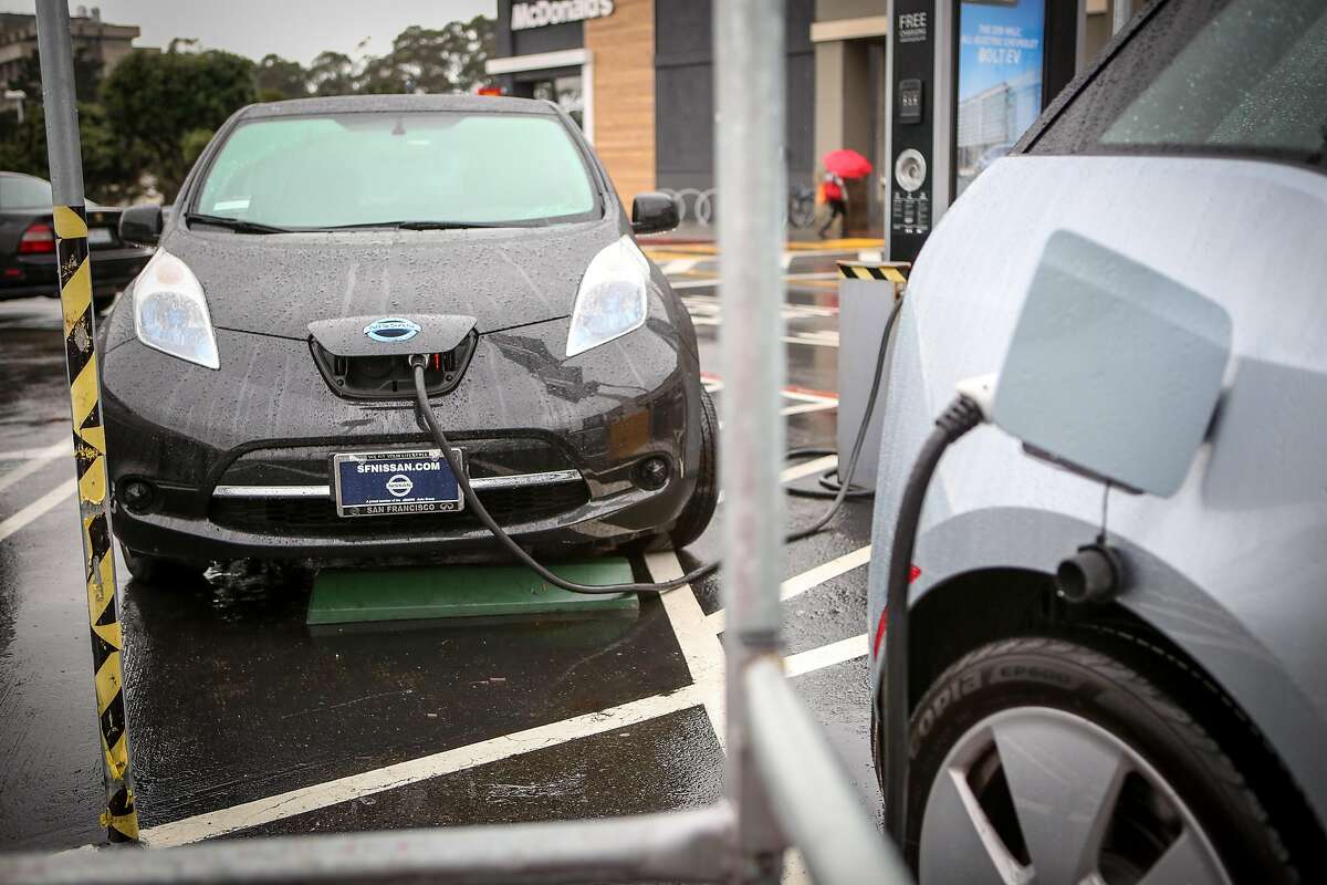 Two electric cars use up the two public charging stations in the Stonestown Galleria parking lot on Thursday, December 8, 2016 in San Francisco, Calif.