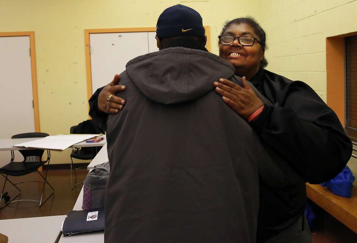 Anita Schools hugs Gregory Ward at a community meeting Nov. 15, 2016 with the East Bay Housing Organization, a local group she is involved with about affordable housing access, education and community organizing at Oakland Housing Authority in Oakland, Calif. Schools has been living with HIV for years and is involved in many different groups and organizations in her area focused not only on HIV but also her community and advocacy of different types.