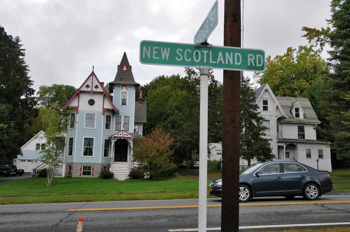 Traffic on New Scotland road passes the "Ironweed House," left, at which scenes from the Jack Nicholson movie of the William Kennedy novel of the same name were filmed in 1987, after a ceremony in which Bethlehem Town Historian Susan Leath unveiled a sign for the new Slingerlands Historic District in 2013. (Philip Kamrass / Times Union)