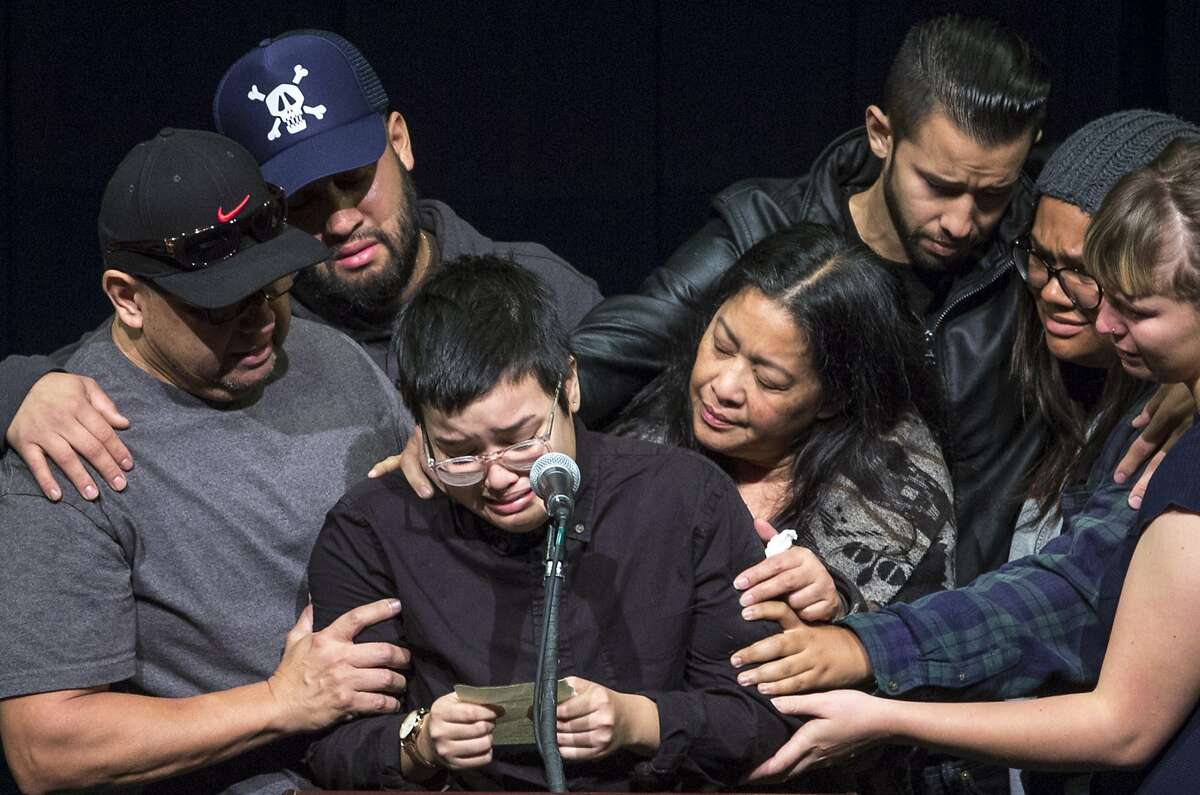 Victoria Plotkin reads from a note she wrote to her sister Vanessa Plotkin, as she is embraced by family and friends on Thursday, Dec. 8, 2016 in Berkeley, Calif. Vanessa, 21, who was Victoria's twin sister, died in the Oakland warehouse fire last week. A vigil was held at Zellerbach Hall for Berkeley undergraduates Jennifer Morris and Vanessa Plotkin, and recently graduated alumni David Cline and Griffin Madden, who all died in an Oakland warehouse fire. 36 people were killed when the fire broke out at the Ghost Ship warehouse on 31st Avenue and International Boulevard in Oakland's Fruitvale neighborhood.