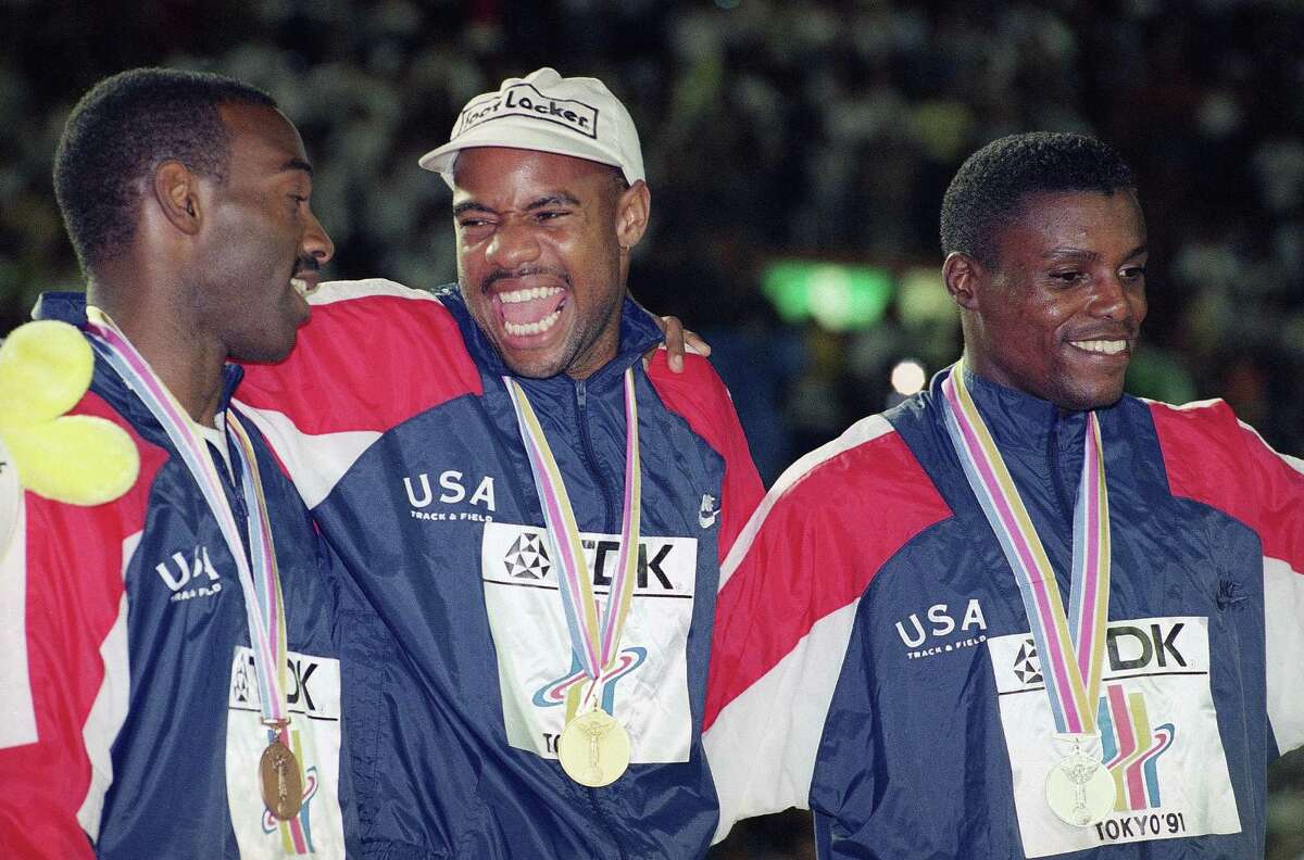 Powell soars into history, stuns Lewis in long jump