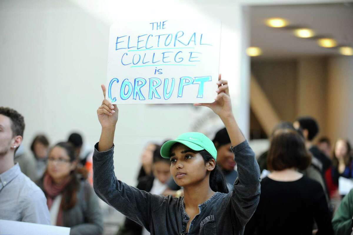 Andrea Joshua, 18, holds a sign reading "the electoral college is corrupt" during the anti-Trump, anti-system demonstration inside UConn Stamford in Stamford, Conn. on Thursday, Nov. 10, 2016. (Photo by Michael Cummo/Hearst Connecticut Media)