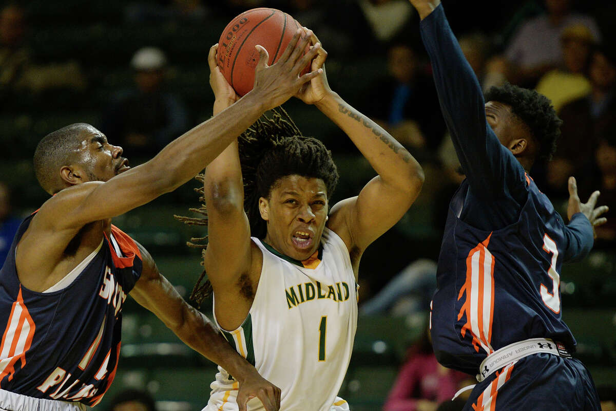 Midland College's Ashawn Jones tries to get past South Plains' Josh Webster (11) and Raquan Mitchell (3) on Wednesday, Nov. 30, 2016, at Chaparral Center. James Durbin/Reporter-Telegram