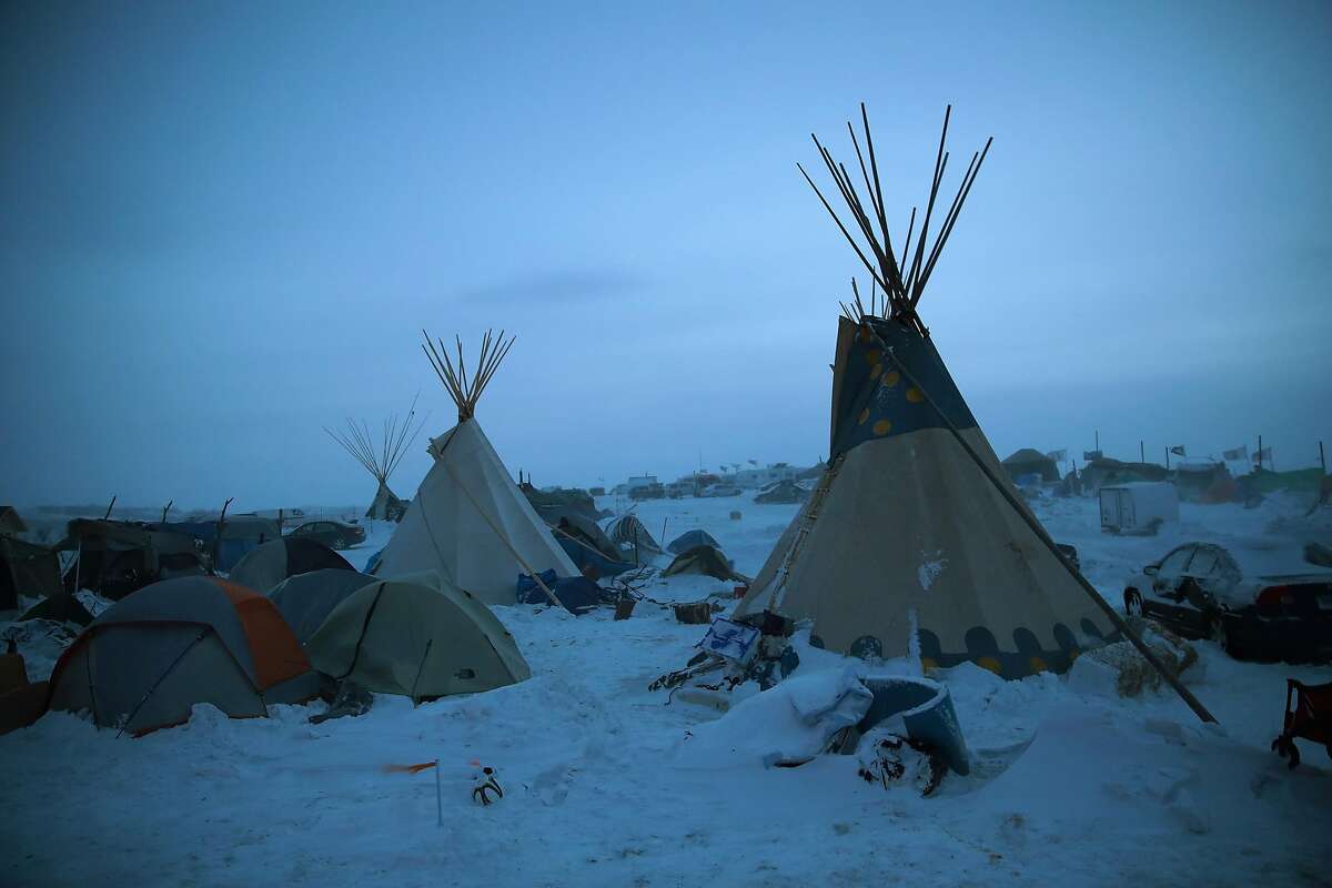 CANNON BALL, ND - DECEMBER 06: Activists at Oceti Sakowin near the Standing Rock Sioux Reservation brace for sub-zero temperatures expected overnight on December 6, 2016 outside Cannon Ball, North Dakota. Native Americans and activists from around the country have been at the camp for several months trying to halt the construction of the Dakota Access Pipeline. The proposed 1,172-mile-long pipeline would transport oil from the North Dakota Bakken region through South Dakota, Iowa and into Illinois. (Photo by Scott Olson/Getty Images)