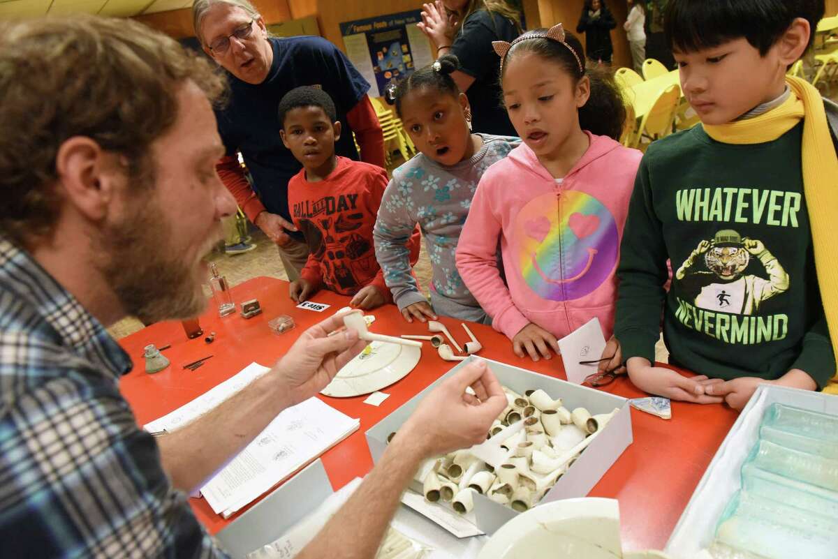Muesum research and collection archaeologist Joshua Debuque works with Thomas O?’Brien Academy of Science and Technology third grade students during a a hands-on archaeology program at the New York State Museum on Friday Dec. 9, 2016 in Albany, N.Y. (Michael P. Farrell/Times Union)