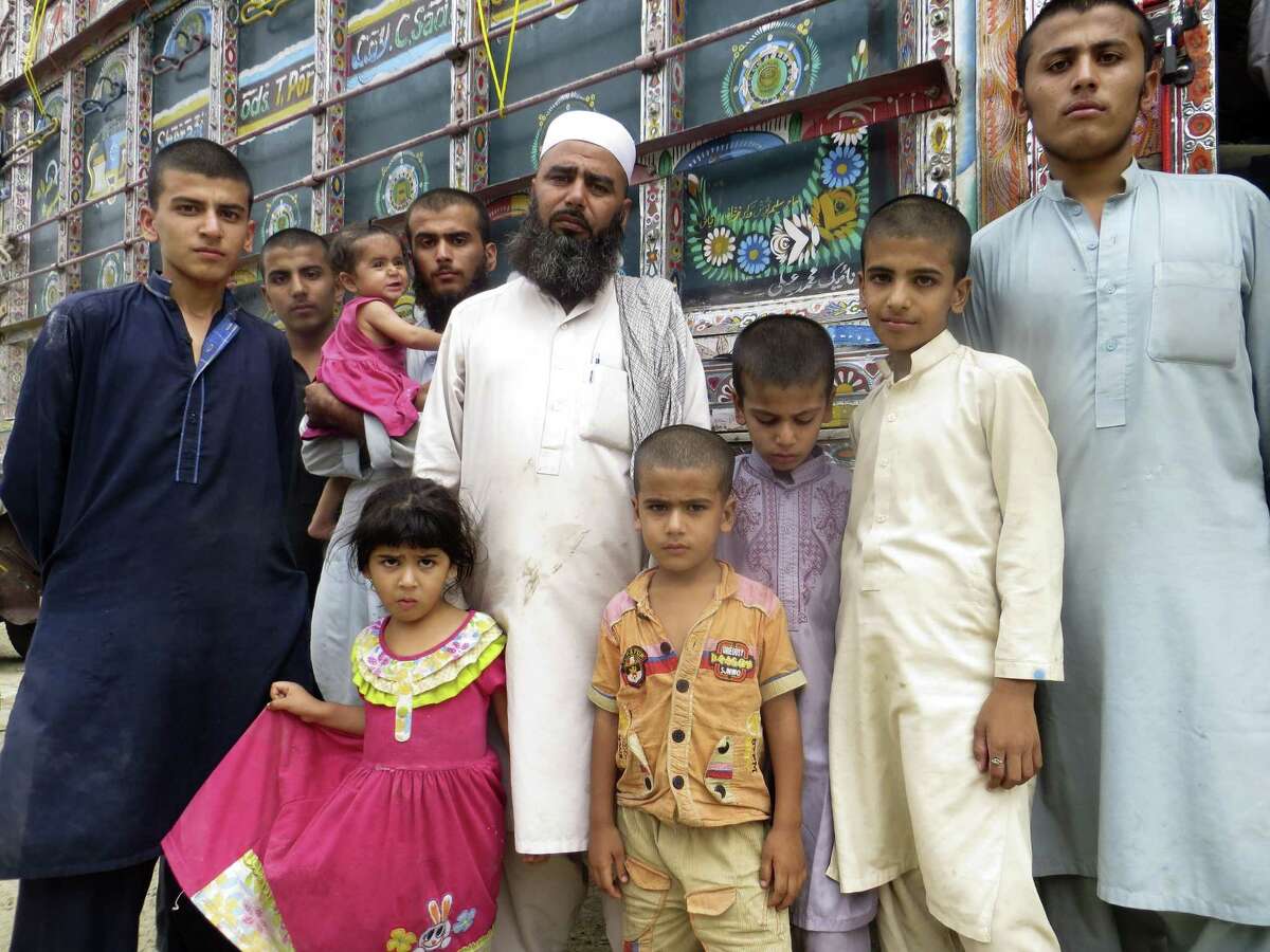 Abdul Yousufzai, who was brought to Pakistan by his parents as a toddler in 1979, was forced to return to his native Afghanistan by the Pakistan government in September. He is shown with members of his extended family at the border crossing in Torkham, where hundreds of thousands of Afghan refugees will re-enter the country from Pakistan in the coming year. Martin Kuz/San Antonio Express-News