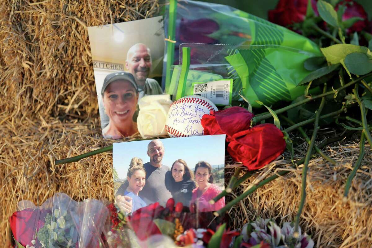 A view of photos, a baseball, and roses left at a memorial Monday Aug. 1, 2016 at the site of a hot air balloon crash that killed 16 people on Saturday July 30, 2016 near Maxwell, Texas in Caldwell County.