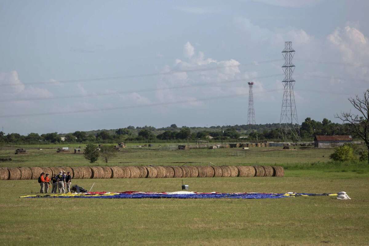Investigators at the site where a hot air balloon crashed, killing 16 people, west of Lockhart, Texas, July 30, 2016. Officials said the craft caught fire in midair and plummeted to the ground in what appeared to be the worst balloon accident in U.S. history. (Tamir Kalifa/The New York Times)