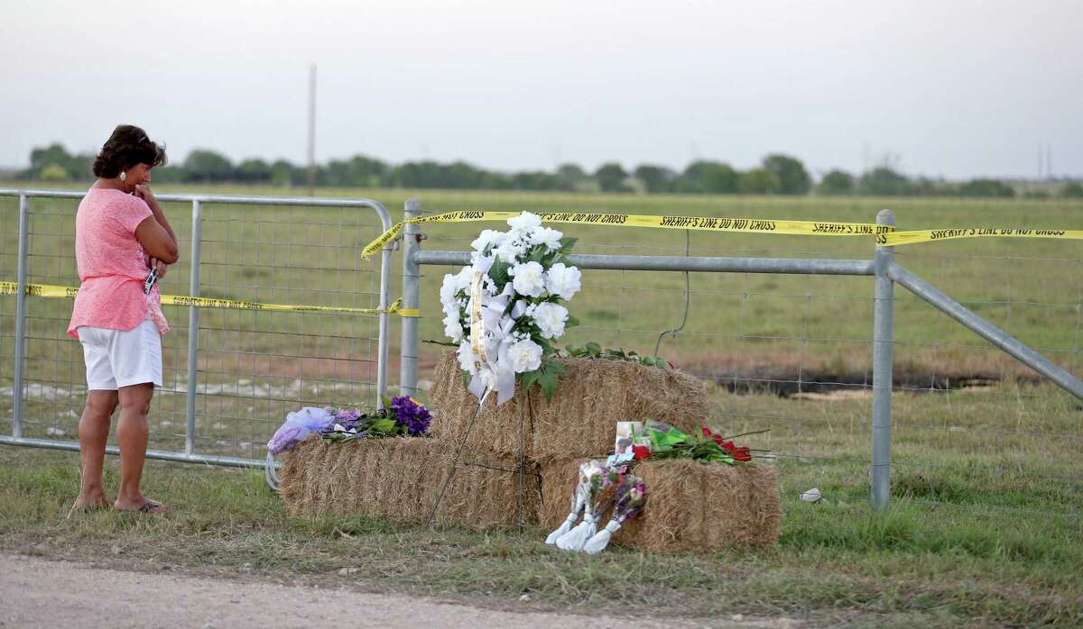 Kathy Stephens, of Kyle, Texas, pauses at a memorial, Monday Aug. 1, 2016, at the site of a hot air balloon crash that killed 16 people on Saturday near Lockhart, Texas. (Edward A. Ornelas/San Antonio Express-News via AP)