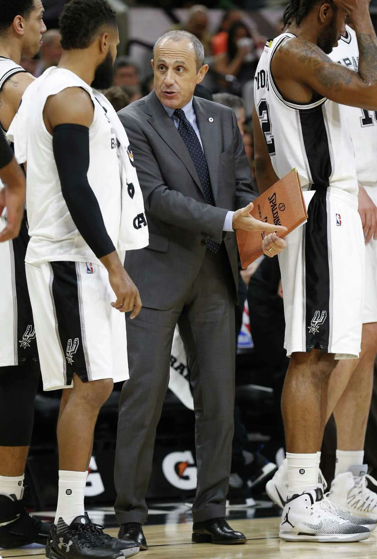 Spurs' assistant coach Ettore Messina (center) talks with Patty Mills (08) during the game against the Orlando Magic at the AT&T Center on Tuesday, Nov. 29, 2016. (Kin Man Hui/San Antonio Express-News)