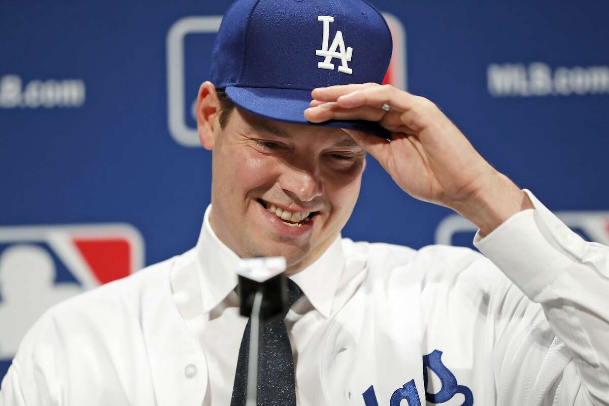 Los Angeles Dodgers pitcher Rich Hill adjusts his cap during a media availability at Major League Baseball's winter meetings, Monday, Dec. 5, 2016 in Oxon Hill, Md. Hill recently signed a 3-year deal to stay with the Dodgers. (AP Photo/Alex Brandon)