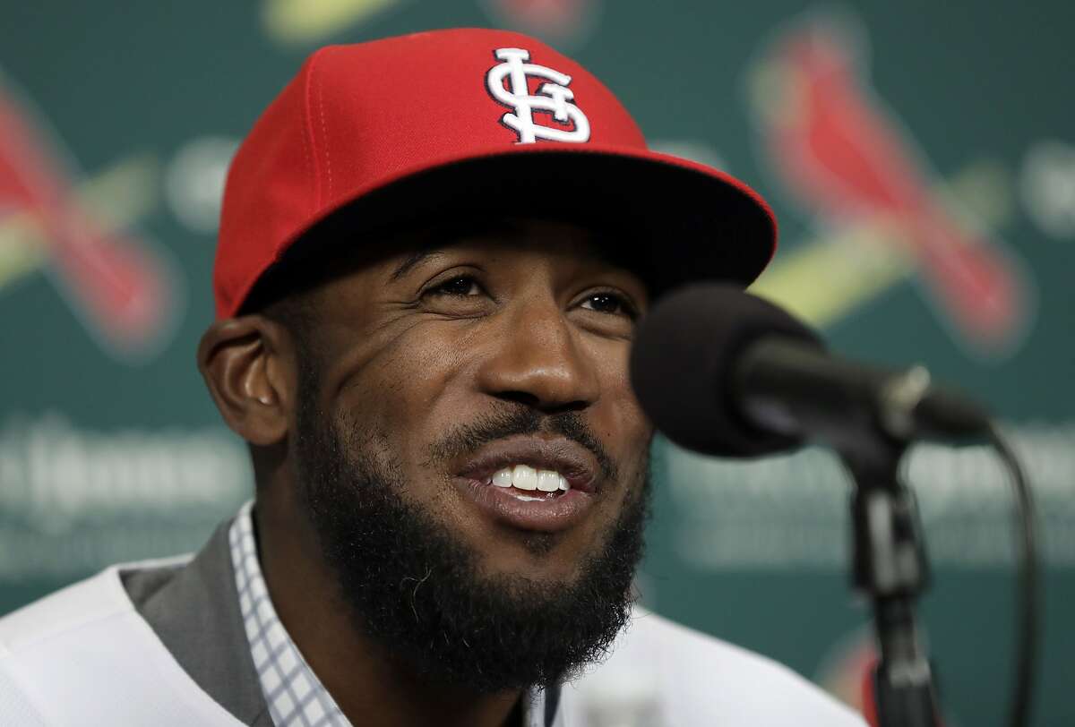 Dexter Fowler smiles during an introductory news conference announcing the free agent center fielder has signed with the St. Louis Cardinals Friday, Dec. 9, 2016, in St. Louis. (AP Photo/Jeff Roberson)
