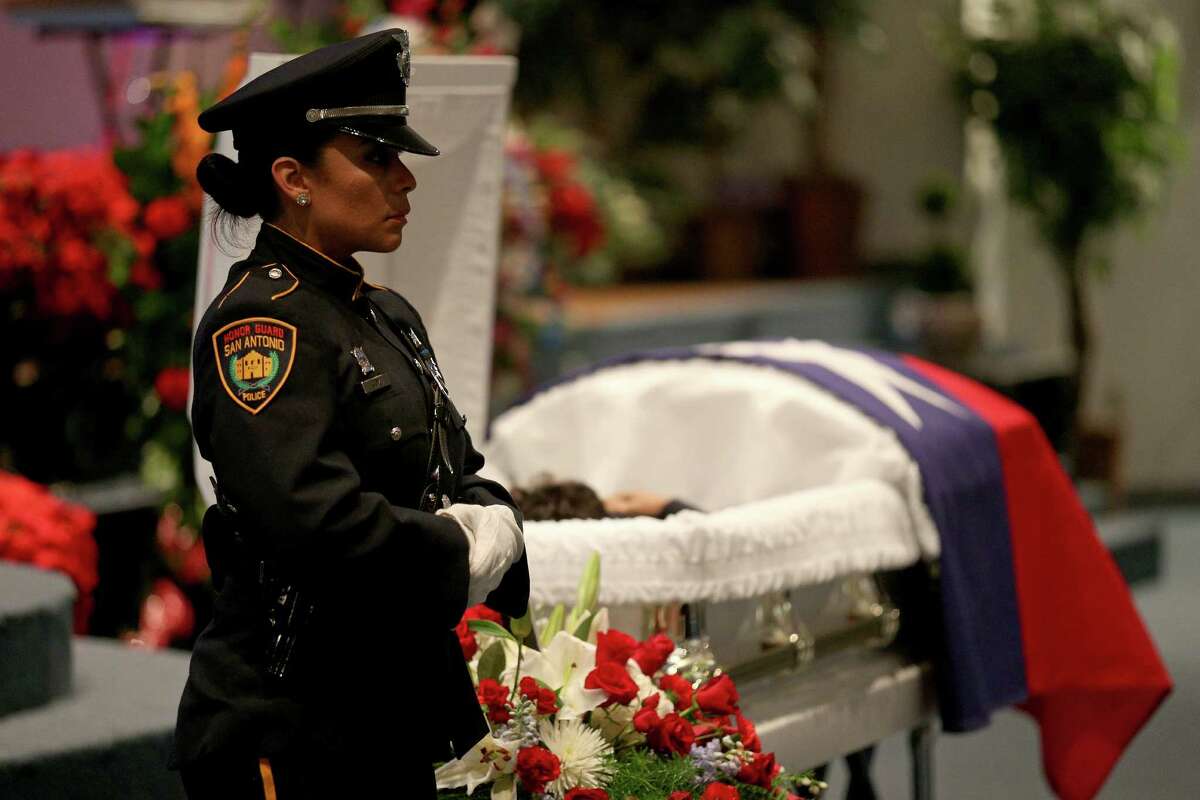 San Antonio Police Department Honor Guard Detective Yvette Coz stands at attention near the casket of Bexar County Sheriff's Office Deputy Doralinda Solis Nishihara during the public viewing held Friday Dec. 9, 2016 at Sendero Assembly of God Church. BCSO Deputy Doralinda Solis Nishihara died after driving her vehicle into a large sinkhole Sunday evening on the Southwest Side.
