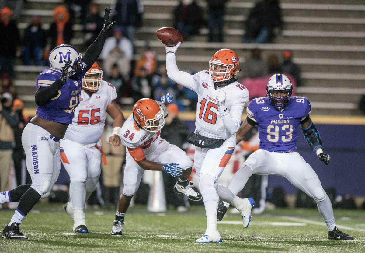 Sam Houston State quarterback Jeremiah Briscoe (16) tries to get a pass off under pressure from James Madison defensive lineman Martez Stone (91) during the first half of an NCAA college football game in Harrisonburg, Va., Friday, Dec. 9, 2016. (Daniel Lin/Daily News-Record via AP)