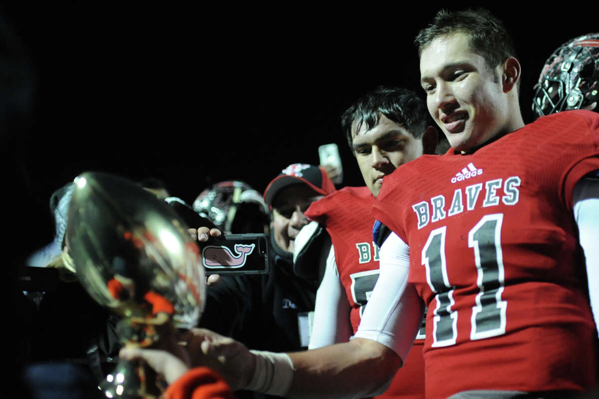 Iraan quarterback Clayton Kent receives the trophy after a win against Wellington in the Class 2A Division II state semifinal game Friday, Dec. 9, 2016, at Shotwell Stadium in Abilene. James Durbin/Reporter-Telegram