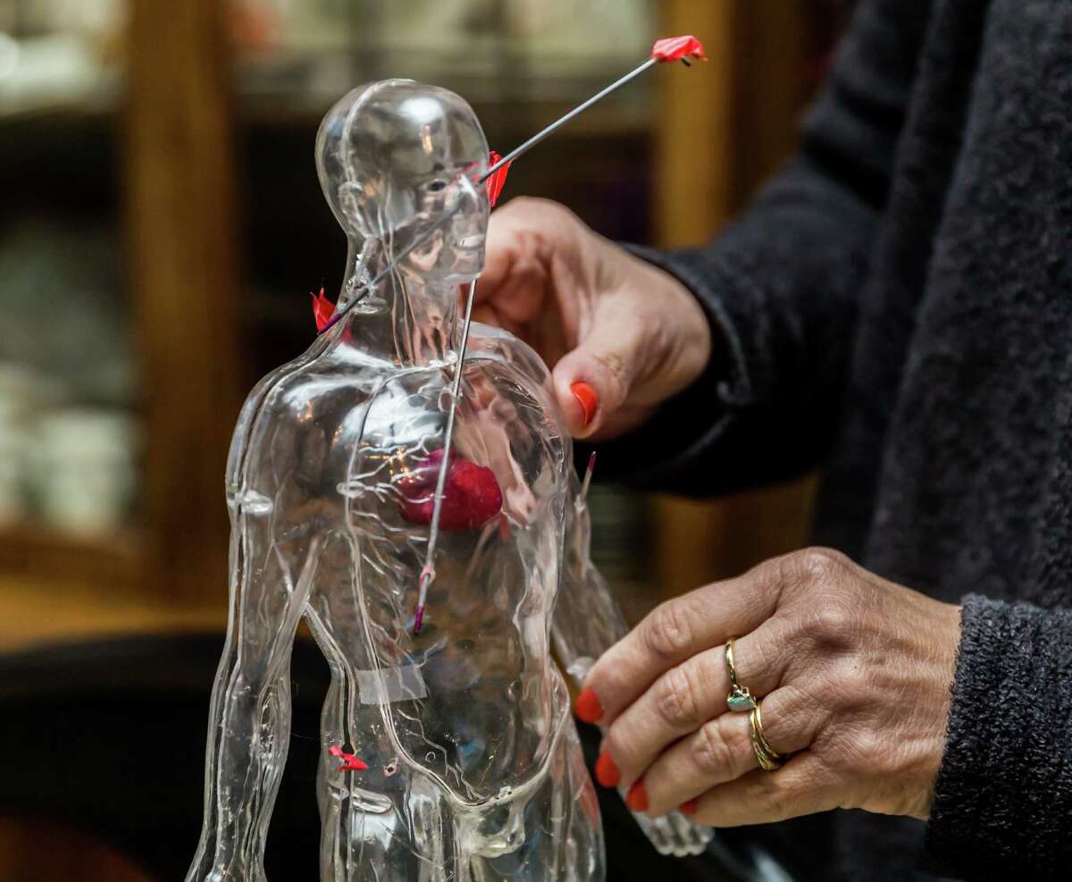 December 9, 2016: Valerie Redus holds a small clear plastic sculpture that depicts the gunshot wounds that took her son Cameron's life. Her husband Mickey Redus created the sculpture at their home in Baytown, Texas. (Leslie Plaza Johnson/Freelance)