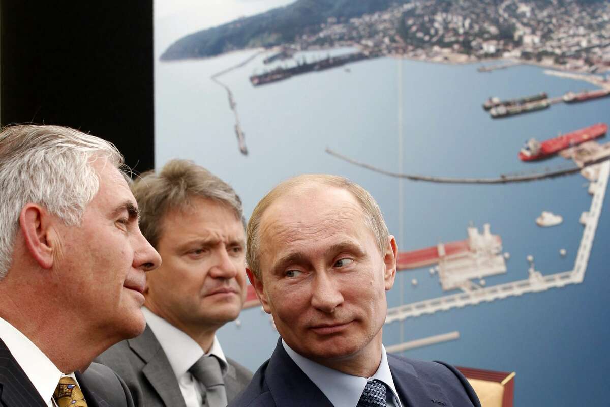 FILE - Russia's President Vladimir Putin (R) and ExxonMobil Chairman and CEO Rex Tillerson (L) attend at the ceremony of the signing of an agreement between state-controlled Russian oil company Rosneft and ExxonMobil in the Black Sea port of Tuapse on June 15, 2012.