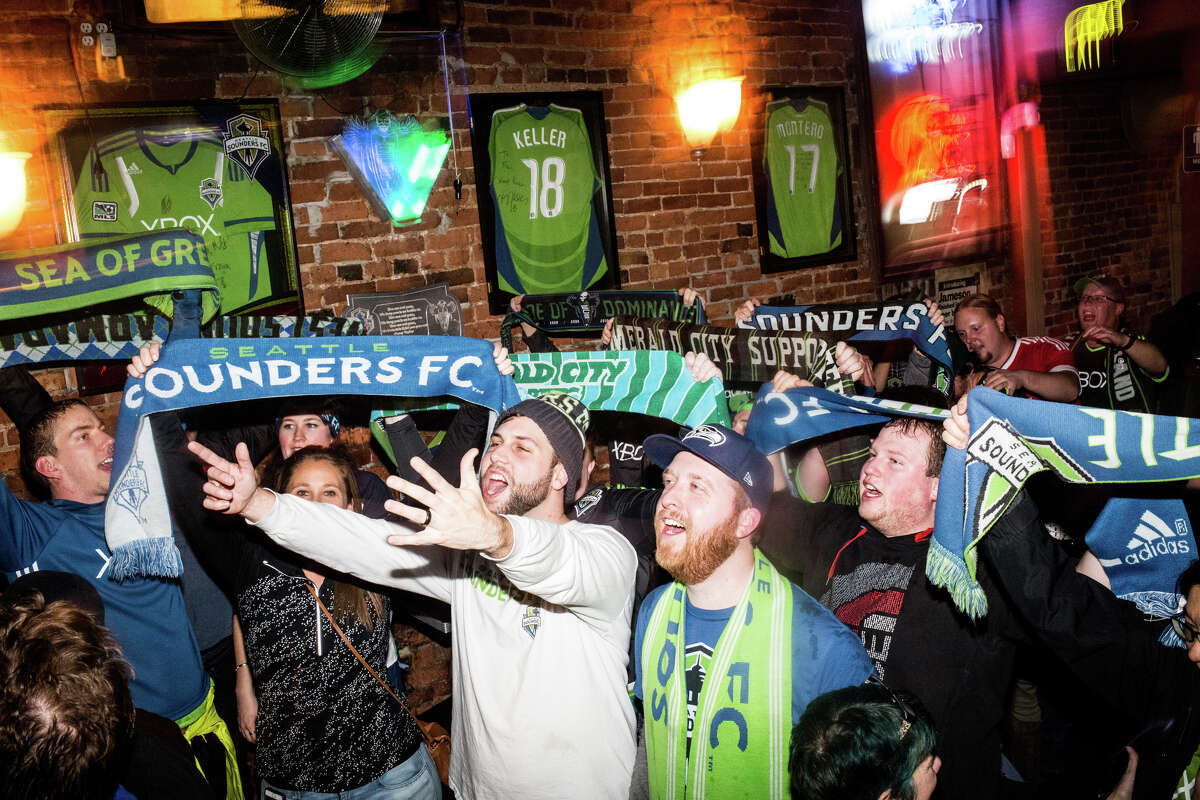 Seattle Sounders fans celebrate following their win over Toronto FC in the MLS Cup, at Fuel Sports in Pioneer Square on Saturday, Dec. 10, 2016.