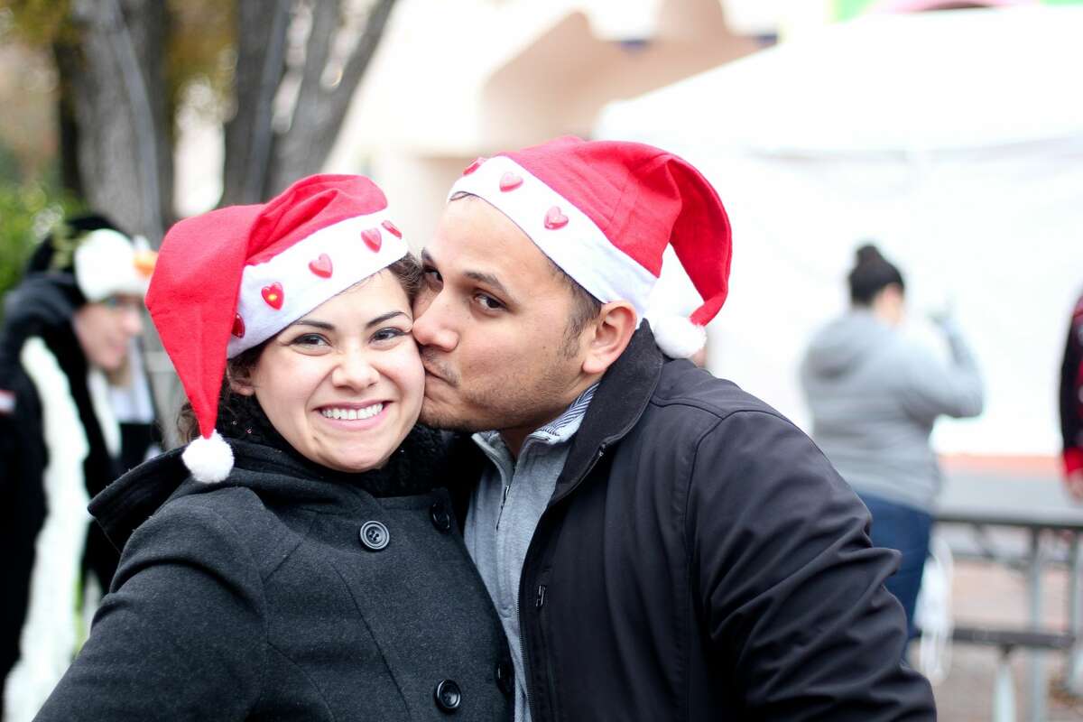 San Antonio puckered up this weekend to set the Guinness World Record of most couples to kiss under mistletoe at Six Flags Fiesta Texas on Saturday, Dec. 10, 2016.