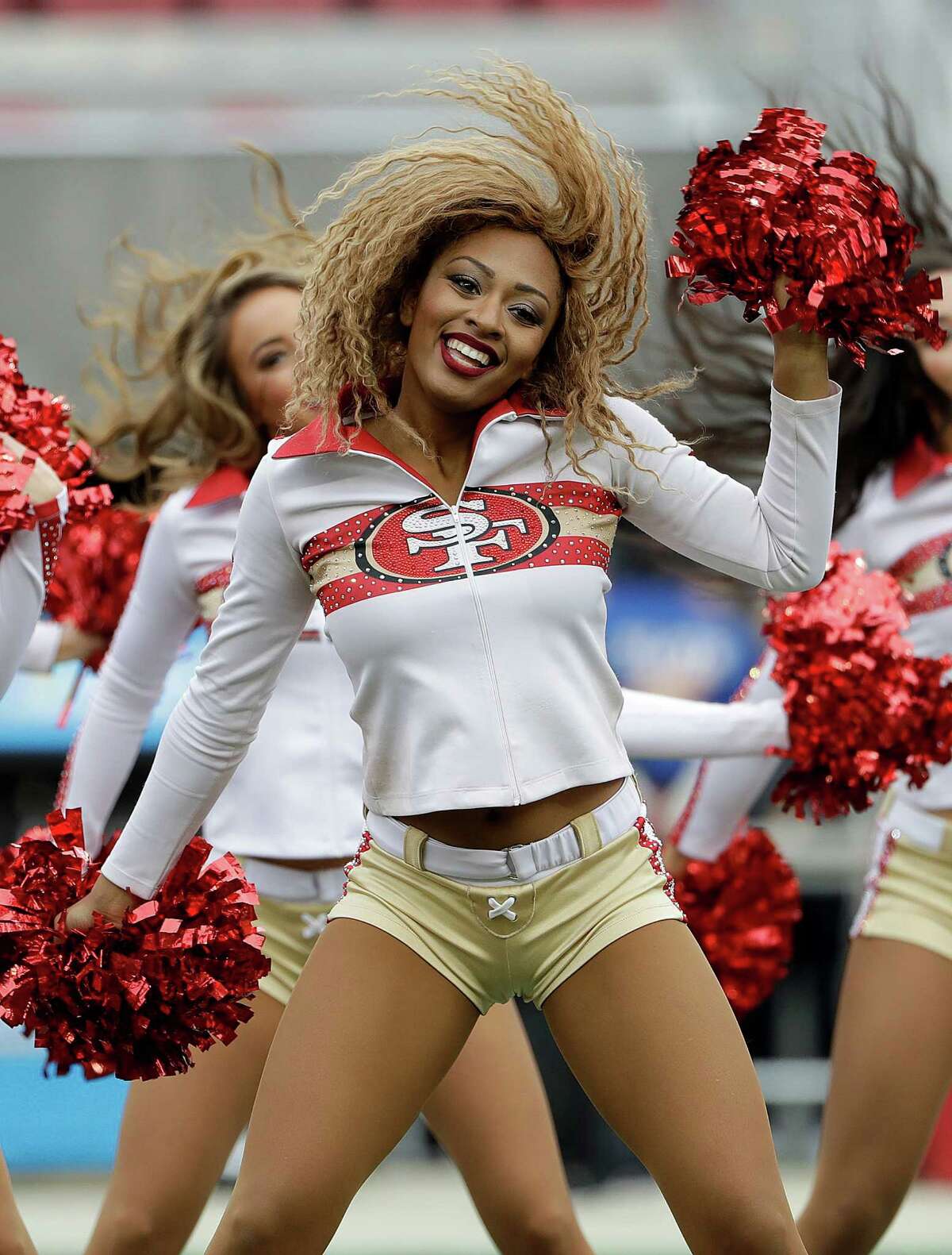 Francisco 49ers cheerleaders perform before an NFL football game between th...