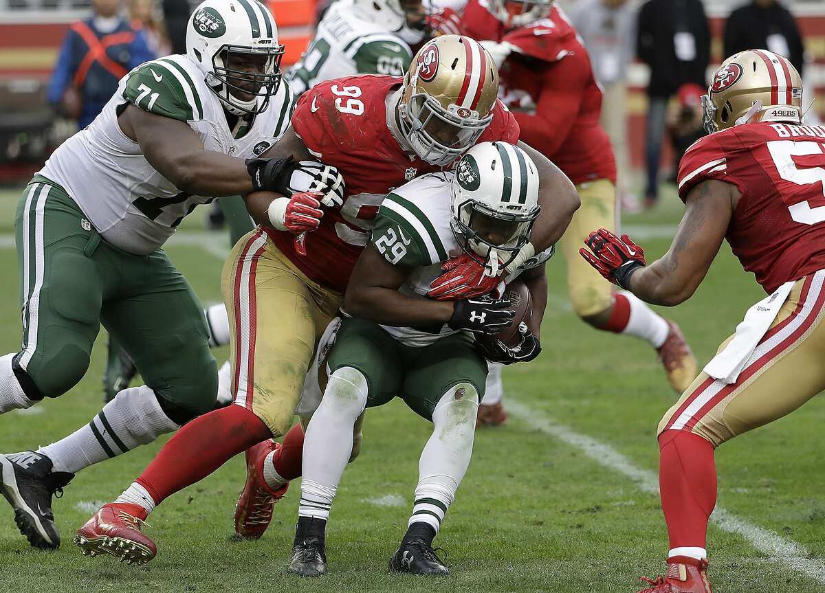New York Jets running back Bilal Powell (29) is tackled by San Francisco 49ers defensive end DeForest Buckner (99) during the second half of an NFL football game in Santa Clara, Calif., Sunday, Dec. 11, 2016. (AP Photo/Marcio Jose Sanchez)
