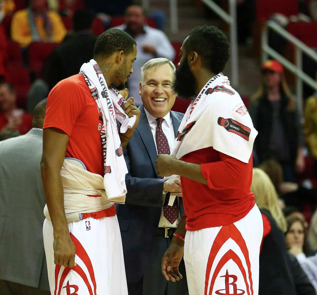 Rockets coach Mike D'Antoni, center, talks with Trevor Ariza, left, and James Harden. D'Antoni says the team is all-in every day, making coaching fun.