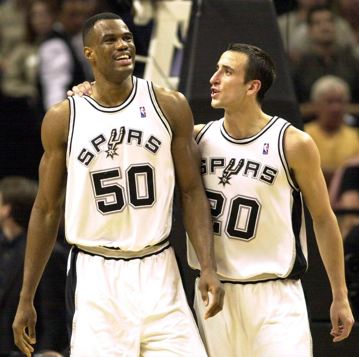 David Robinson and Manu Ginobili are all smiles near the end of a 2003 playoff game.