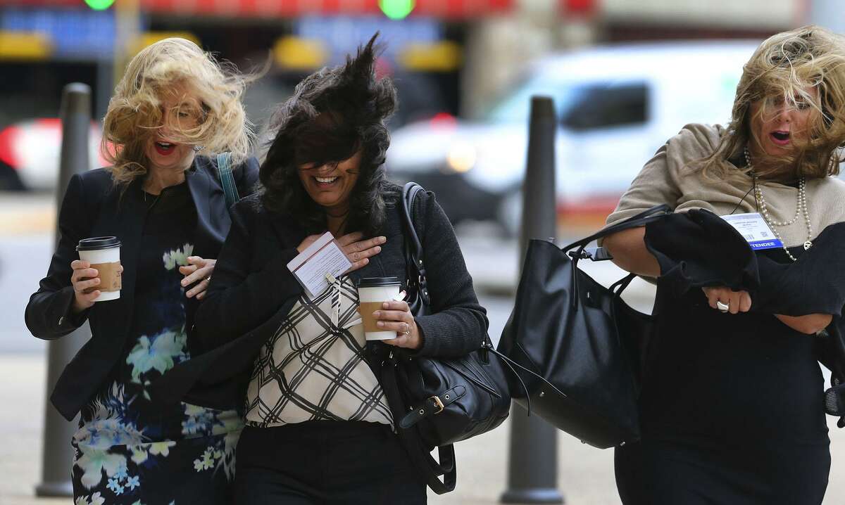 Pedestrians brave high winds Thursday December 8, 2016 while crossing Market street at the intersection of Bowie at the Henry B. Gonzalez Convention Center in downtown San Antonio. The National Weather Service has issued a wind advisory for most of central Texas with gusts as high as 40 mile per hour.