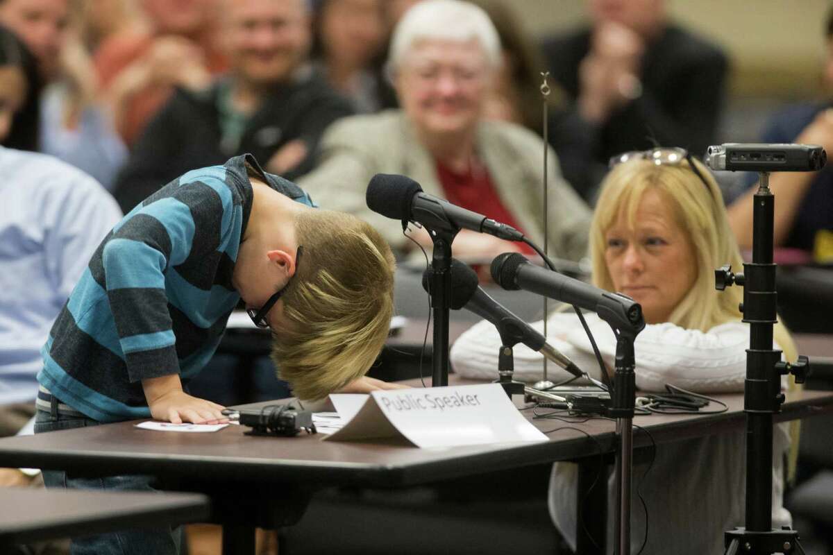 Chris Crowley, 10, talks about issues at his school with support from his mother, Camilyn Marceaux, right, at a hearing Monday in Houston with federal and state education officials.