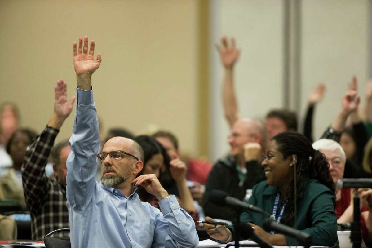 Parents of children with disabilities who are paying for supportive services outside of the school system raise their hands during a hearing with the representatives from the U.S. Department of Education's Office of Special Education and Rehabilitative Services (OSERS) and the Texas Education Agency (TEA), Monday, Dec. 12, 2016, in Houston. ( Marie D. De Jesus / Houston Chronicle )