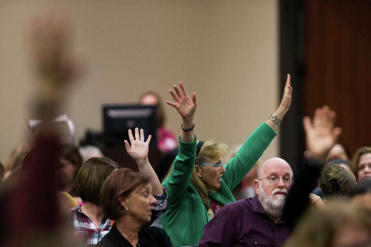 Parents of children with disabilities who are paying for supportive services outside of the school system raise their hands during a hearing with the representatives from the U.S. Department of Education's Office of Special Education and Rehabilitative Services (OSERS) and the Texas Education Agency (TEA), Monday, Dec. 12, 2016, in Houston.