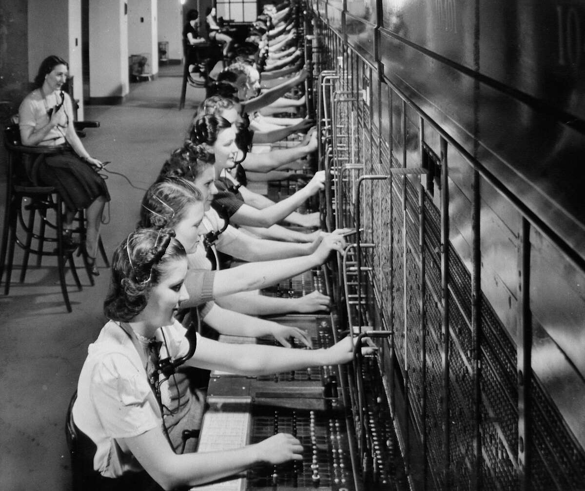 Women using telephone switchboards
