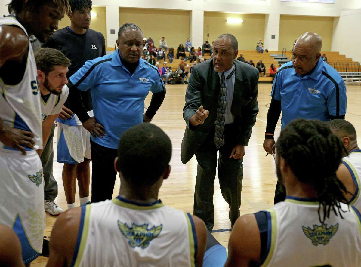 Former Spurs point guard Johnny Moore, now head coach of the Universal City Seraphim, (center) talks with the team during a timeout in first half action against the Texas Sky Riders on Dec. 3, 2016 at Northeast Lake View College.