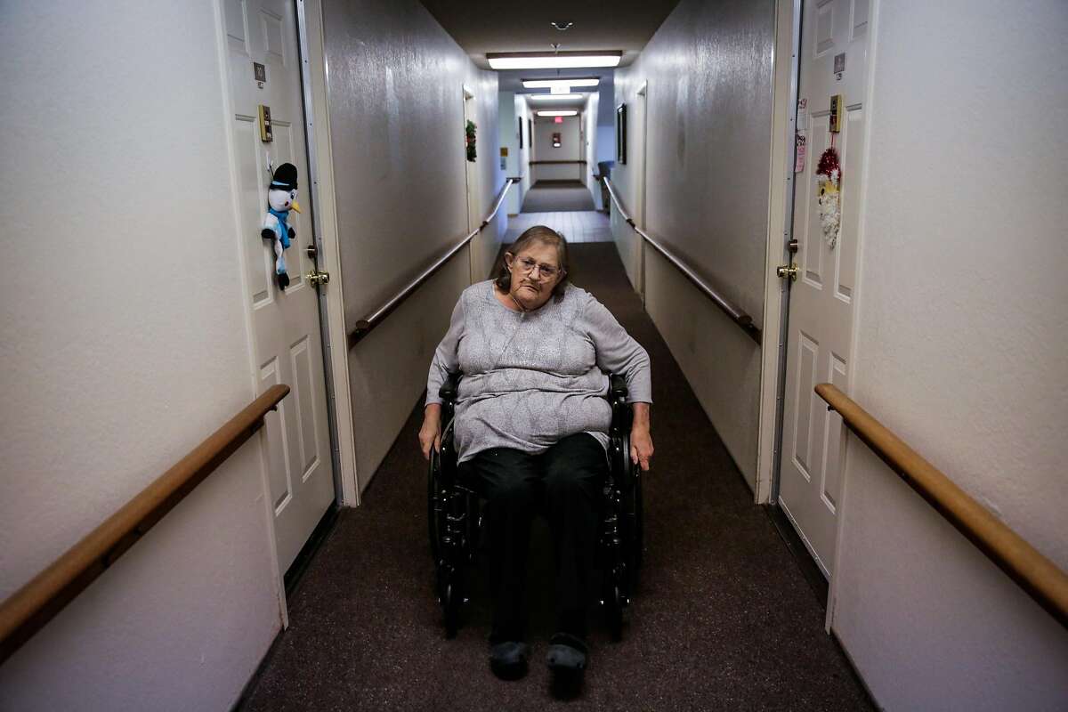 Sandra Quiroz, a senior who was recently evicted from a mobile home park when it was sold to a developer, wheels down the hallway of her apartment complex, in Benicia, Calif., on Sunday, Dec. 11, 2016. Quiroz, who is on oxygen and dialysis, was in danger of becoming homeless until the Benicia Community Action Council stepped in and found her a new place to live in an affordable senior housing residence.