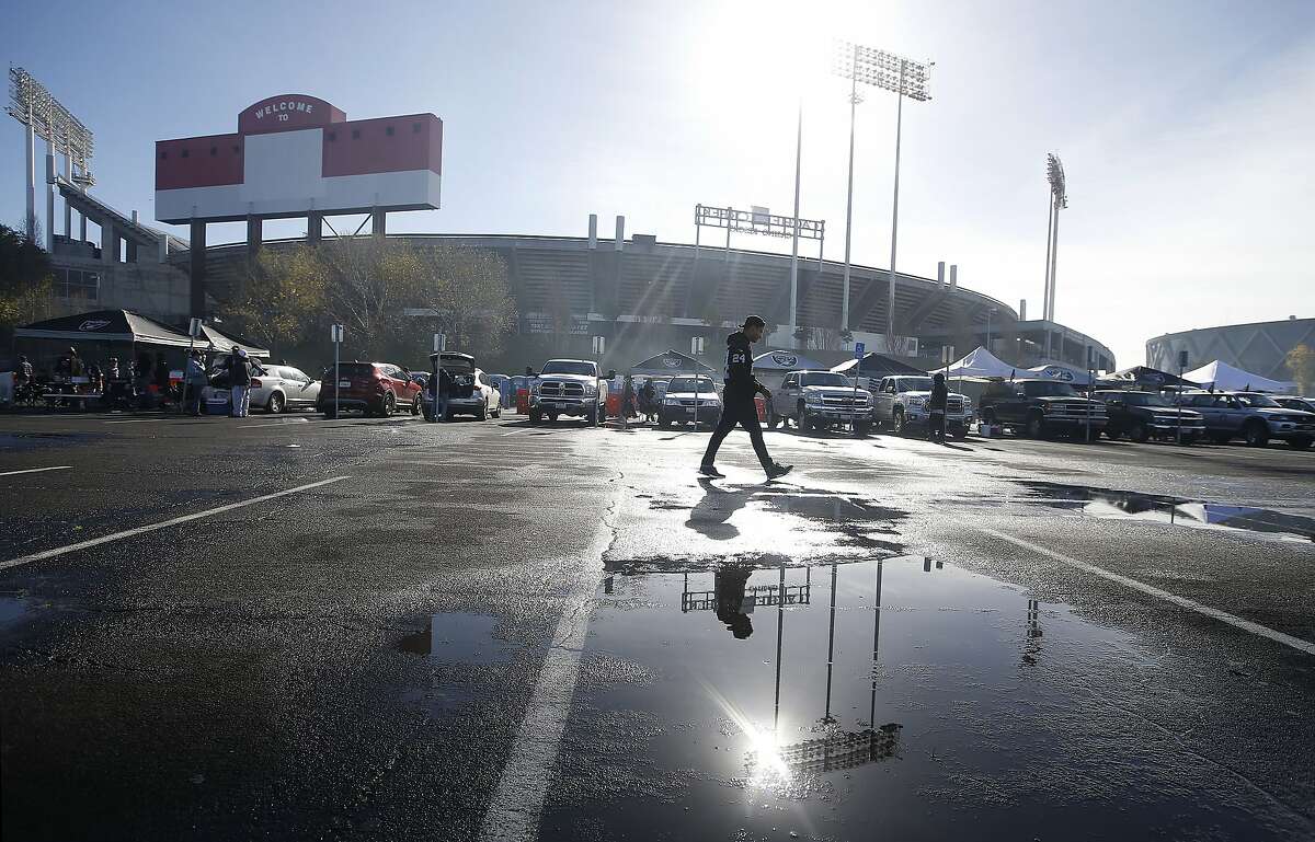 Fans tailgate outside of Oakland Alameda County Coliseum before an NFL football game between the Oakland Raiders and the Carolina Panthers in Oakland, Calif., Sunday, Nov. 27, 2016. (AP Photo/Tony Avelar)