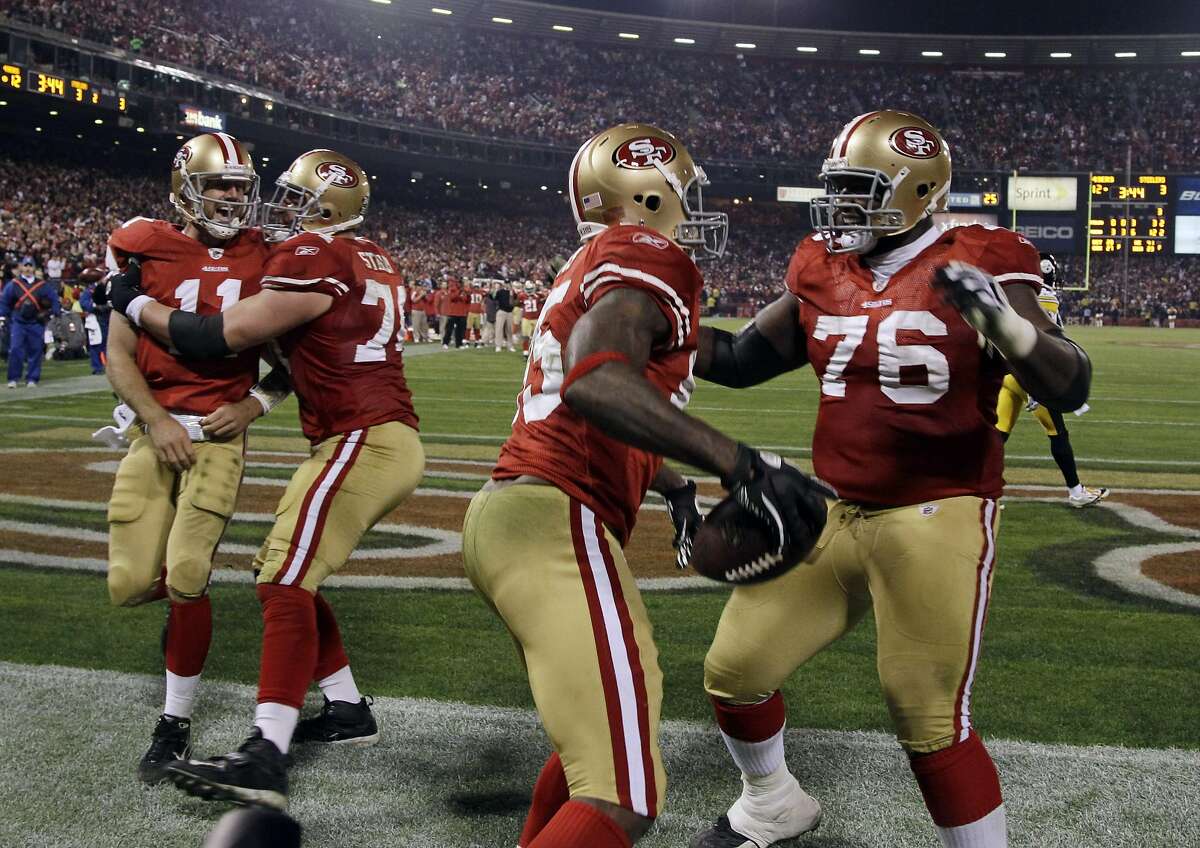 San Francisco 49ers tight end Vernon Davis (85) celebrates his touchdown with teammate Anthony Davis, right, as quarterback Alex Smith (11) is congratulated by Joe Staley in the third quarter of an NFL football game against the Pittsburgh Steelers in San Francisco, Monday, Dec. 19, 2011. (AP Photo/Paul Sakuma)