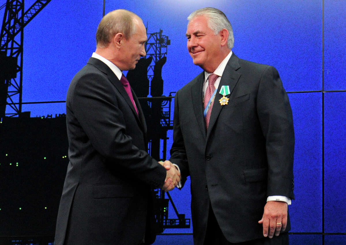 In this photo taken Thursday, June 21, 2012, Russian President Vladimir Putin presents ExxonMobil CEO Rex Tillerson with a Russian medal at an award ceremony of heads and employees of energy companies at the St. Petersburg economic forum in St. Petersburg, Russia. An aide to President Vladimir Putin praised United States President-elect Donald Trump?’s choice of Rex Tillerson to lead the State Department and says that the businessman is well regarded by many Russian officials. (Mikhail Klimentyev/Sputnik, Kremlin Pool Photo via AP)